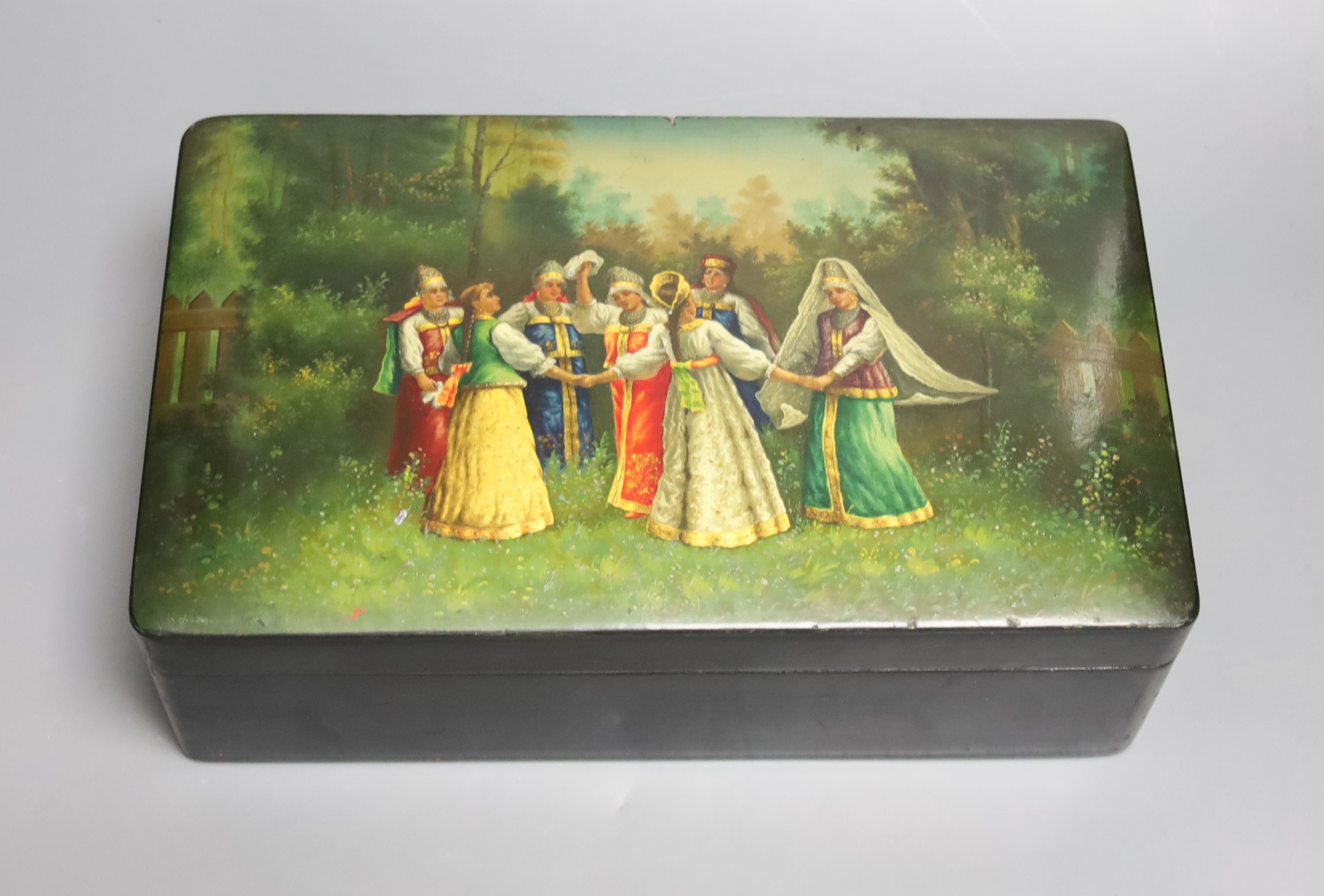 A 19th century Russian lacquer box, decorated with dancers to the cover, and signed lower left, 29 x 18cm